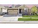 Charming single-Gathering home showcasing a landscaped front yard, attached garage and inviting entry way at 18340 W 85Th Dr, Arvada, CO 80007