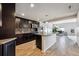 Modern kitchen with dark cabinets, granite countertops, and stainless steel appliances at 18340 W 85Th Dr, Arvada, CO 80007