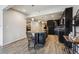 Stylish kitchen featuring dark cabinetry, a large island, and modern lighting fixtures at 18340 W 85Th Dr, Arvada, CO 80007