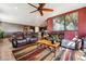 Cozy living room with ceiling fan, plush seating, and warm-toned decor creating an inviting atmosphere at 18340 W 85Th Dr, Arvada, CO 80007