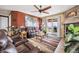 Comfortable living room showcasing a fireplace, leather sofas, and a sliding glass door to an outdoor space at 18340 W 85Th Dr, Arvada, CO 80007