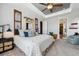Tranquil main bedroom featuring neutral colors, tray ceiling, and comfortable seating area at 18340 W 85Th Dr, Arvada, CO 80007