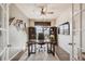 Well-lit home office featuring a desk, ergonomic chair, shelving, and an outside view from the window at 18340 W 85Th Dr, Arvada, CO 80007