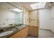 Elegant bathroom featuring a double sink vanity, skylight, and walk-in shower at 2938 Kalmia Ave # 6, Boulder, CO 80301