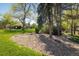 Well-maintained community grounds with mature trees, green grass, and common spaces at 2938 Kalmia Ave # 6, Boulder, CO 80301