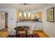 Cozy dining area featuring modern pendant lighting and an adjacent kitchen with stainless steel appliances at 2938 Kalmia Ave # 6, Boulder, CO 80301
