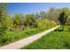 Scenic walking path beside a tranquil pond with lush greenery, perfect for leisurely strolls at 2938 Kalmia Ave # 6, Boulder, CO 80301