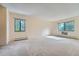 Bright bedroom with neutral carpeting, large windows, and baseboard heaters for a comfortable living space at 14001 E Marina Dr # 211, Aurora, CO 80014