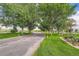 Picturesque driveway lined with mature trees and manicured lawns on a sunny day at 14001 E Marina Dr # 211, Aurora, CO 80014