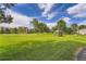 Expansive grassy area with mature trees, gazebo, and residential buildings under a bright sky at 14001 E Marina Dr # 211, Aurora, CO 80014