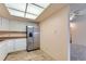 Bright kitchen featuring stainless steel refrigerator, ample cabinet space, and easy access to other rooms at 14001 E Marina Dr # 211, Aurora, CO 80014