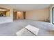 Spacious living room with neutral carpeting and ample natural light, adjacent to a kitchen area at 14001 E Marina Dr # 211, Aurora, CO 80014