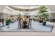 Elegant lobby area with seating arrangements and abundant plants for a welcoming atmosphere at 14001 E Marina Dr # 211, Aurora, CO 80014