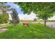 Serene park setting with a bench for relaxation under the shade of mature trees at 14001 E Marina Dr # 211, Aurora, CO 80014