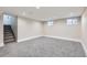 Basement with neutral carpet, bright lighting, and two small windows at 3532 N Vine St, Denver, CO 80205