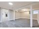 Finished basement area with neutral carpet, support beams, and bright lighting at 3532 N Vine St, Denver, CO 80205