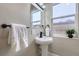 Bathroom featuring a pedestal sink, mirror and a small plant to enhance the space at 3532 N Vine St, Denver, CO 80205