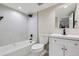 This bathroom features a modern, remodeled shower and white vanity at 3532 N Vine St, Denver, CO 80205