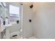 Renovated bathroom with modern shower stall and a pedestal sink at 3532 N Vine St, Denver, CO 80205