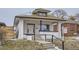 Charming front exterior of a white two-story home featuring a front porch with stairs and a 'for sale' sign at 3532 N Vine St, Denver, CO 80205