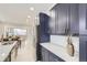 Modern kitchen with dark blue cabinets, stainless steel appliances, and quartz countertops at 3532 N Vine St, Denver, CO 80205