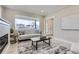 Comfortable living room with a large window offering natural light with a sofa, and an adjacent doorway at 3532 N Vine St, Denver, CO 80205