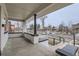 A covered front porch offering a view of the street and the 'for sale' sign in the front yard at 3532 N Vine St, Denver, CO 80205