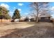 Large backyard with mature trees and a storage shed provides the space for outdoor entertaining at 4751 S Xenia St, Denver, CO 80237