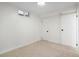 Basement with neutral carpet and paint and two closets providing ample storage at 4751 S Xenia St, Denver, CO 80237