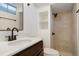 Bathroom showcasing tiled walk-in shower, designer fixtures, and modern vanity at 4751 S Xenia St, Denver, CO 80237