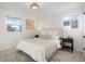 Cozy bedroom with neutral tones, carpet, and ample natural light at 4751 S Xenia St, Denver, CO 80237