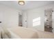 Bright bedroom featuring a neutral color palette and adjacent bathroom at 4751 S Xenia St, Denver, CO 80237