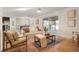 Open-concept living room with lots of natural light leads to dining area and outdoor patio at 4751 S Xenia St, Denver, CO 80237