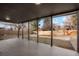 View of the backyard from the covered patio, showcasing the spacious lawn and wood privacy fence at 4751 S Xenia St, Denver, CO 80237