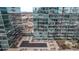 High-angle view of community pools, lounge seating and Glass House condominiums at 1700 Bassett St # 820, Denver, CO 80202