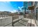 Modern balcony with railing, concrete walls, and views of the vibrant cityscape at 1700 Bassett St # 820, Denver, CO 80202