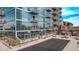 Modern glass condominium building featuring private balconies and a community pool at 1700 Bassett St # 820, Denver, CO 80202