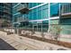 Contemporary glass condo building with lush landscaping and individual outdoor space at 1700 Bassett St # 820, Denver, CO 80202