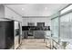 Modern kitchen with stainless steel appliances, black subway tile backsplash, and table with seating at 1700 Bassett St # 820, Denver, CO 80202
