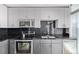 Modern kitchen features stainless steel appliances, dark countertops, and black backsplash at 1700 Bassett St # 820, Denver, CO 80202