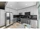 Modern kitchen features stainless steel appliances, sleek dark countertops and black backsplash at 1700 Bassett St # 820, Denver, CO 80202