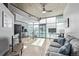 Bright living room showcasing open floorplan, exposed concrete ceilings, and expansive windows with natural light at 1700 Bassett St # 820, Denver, CO 80202