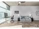 Living room featuring gray sofa, wood-style floors, concrete ceiling and large windows offering plenty of sunlight at 1700 Bassett St # 820, Denver, CO 80202