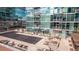 Rooftop pool deck and patio area with lounge chairs at modern condo building with glass facade at 1700 Bassett St # 820, Denver, CO 80202