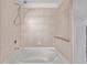 Bright shower-tub combination with neutral tile and convenient shelving for a comfortable bathing experience at 1700 Bassett St # 820, Denver, CO 80202