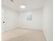 This basement features neutral carpet, a bright window, and a neutral color palette at 6087 S Elizabeth Way, Centennial, CO 80121