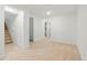 Basement featuring neutral carpet, bright white walls, a staircase, and a hallway with patterned tile at 6087 S Elizabeth Way, Centennial, CO 80121