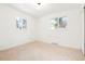 Bright bedroom featuring neutral carpet, two windows, and freshly painted white walls at 6087 S Elizabeth Way, Centennial, CO 80121