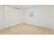 Bedroom featuring neutral carpet, bright white walls, a closet, and a window providing natural light at 6087 S Elizabeth Way, Centennial, CO 80121