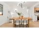 Bright dining area features modern lighting, a wooden table, and seating for four at 6087 S Elizabeth Way, Centennial, CO 80121